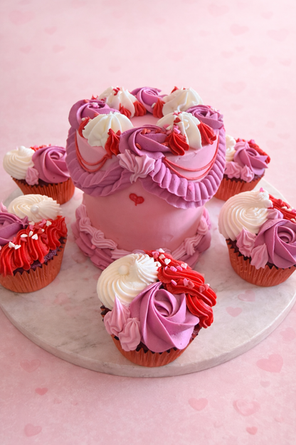Decorative pink cake with cupcakes on a pink background