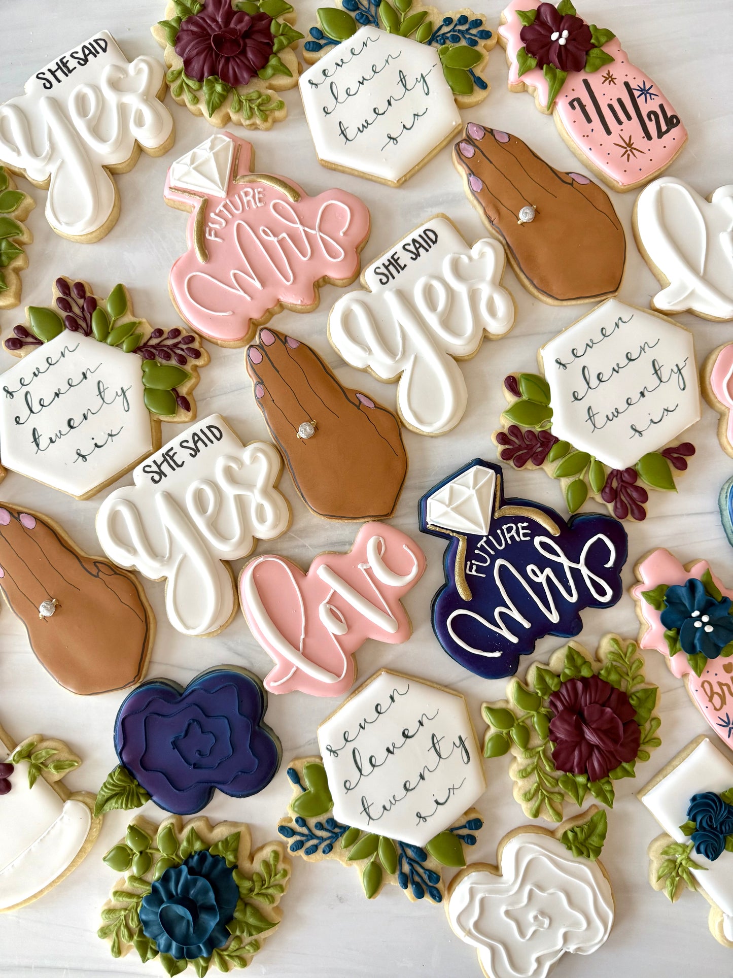 Decorative cookies with text and floral designs on a white background