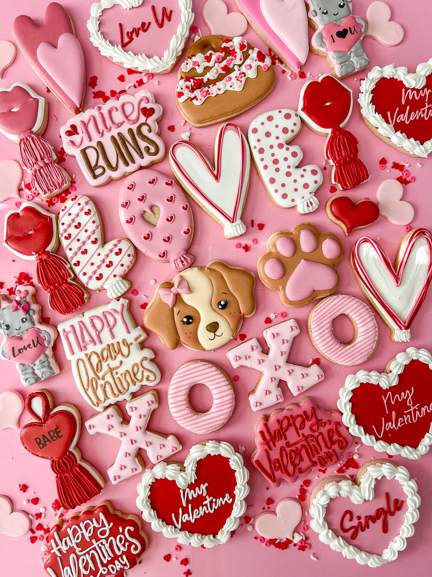Valentine's Day-themed cookies on a pink background