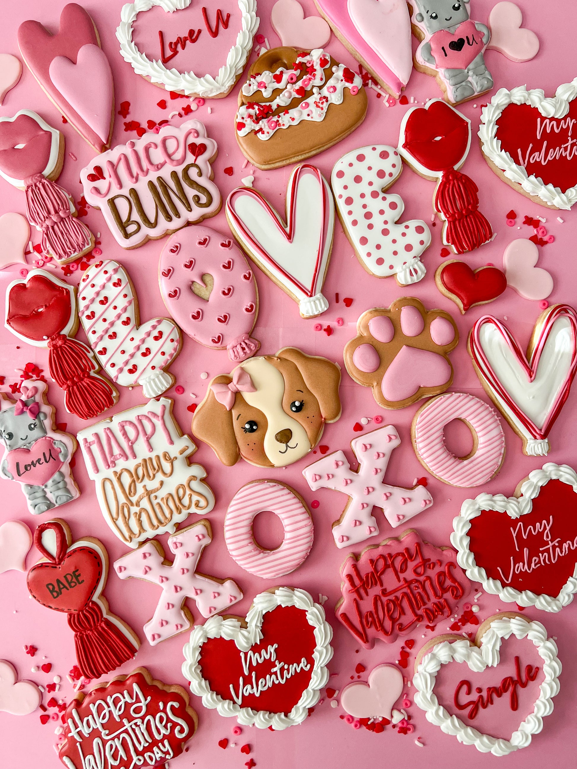 Valentine's Day-themed cookies on a pink background