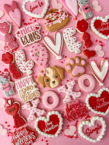 Valentine's Day-themed cookies on a pink background
